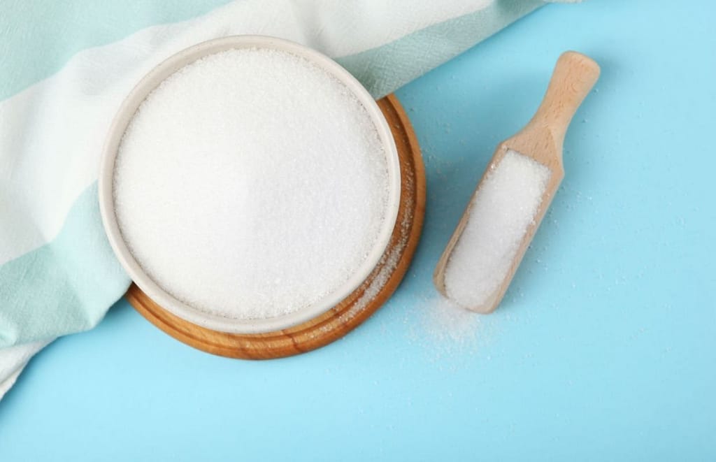 erythritol in a wooden holder with a wooden spoon